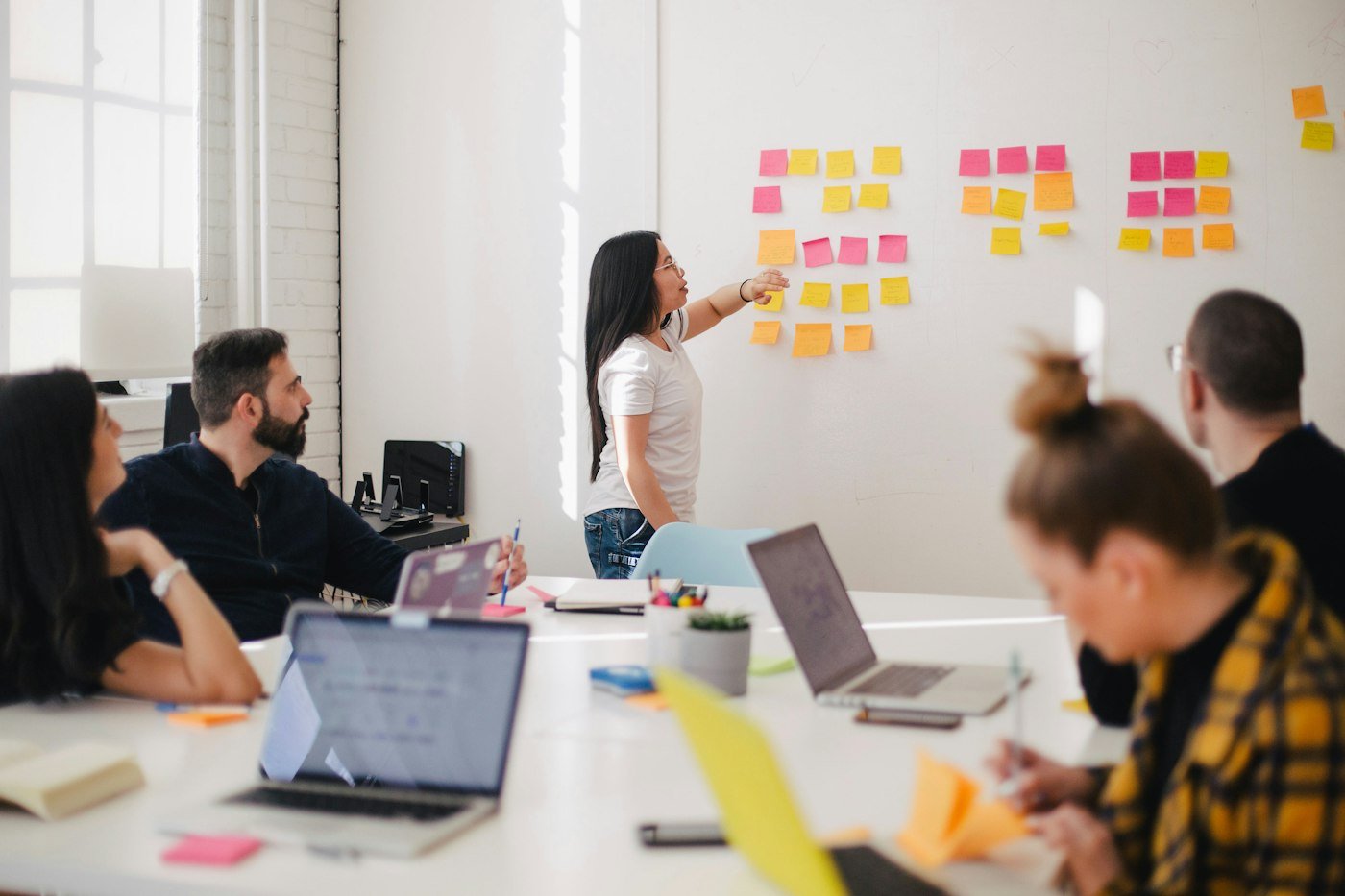 Planning a marketing strategy with sticky notes on a wall